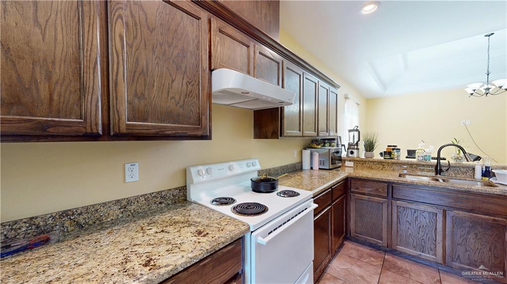 731 North Tower Road Alamo, TX 78516 - Photo 13 of 28 a kitchen with a sink stove and cabinets