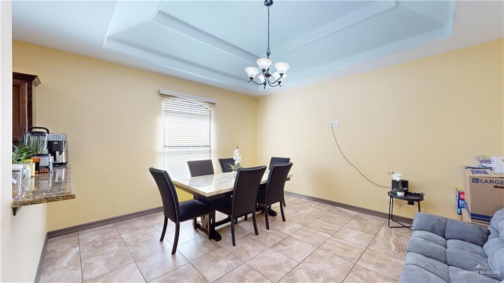 731 North Tower Road Alamo, TX 78516 - Photo 17 of 28 a view of a dining room with furniture and a chandelier