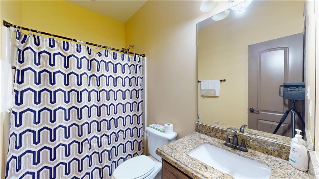 731 North Tower Road Alamo, TX 78516 - Photo 19 of 28 a bathroom with a granite countertop sink and a mirror