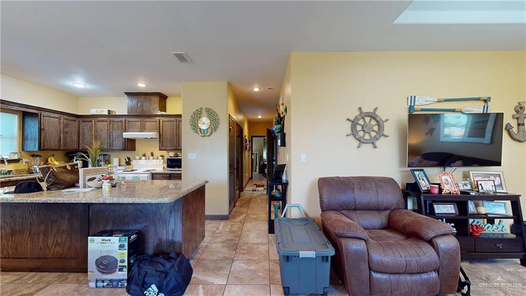 731 North Tower Road Alamo, TX 78516 - Photo 28 of 28 a living room with furniture kitchen view and a flat screen tv