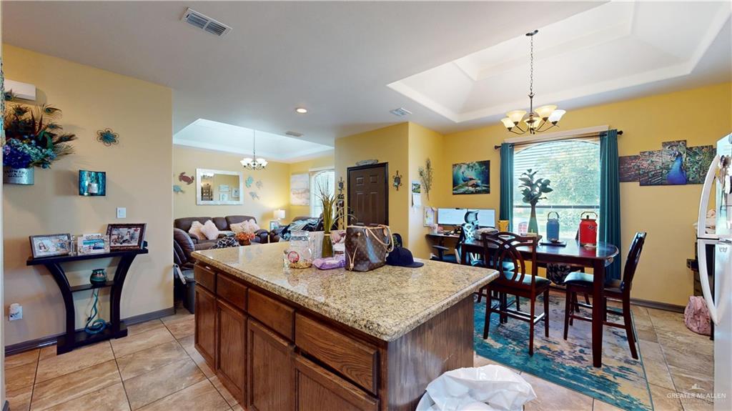 731 North Tower Road Alamo, TX 78516 - Photo 21 of 28 a view of a dining room with furniture and chandelier