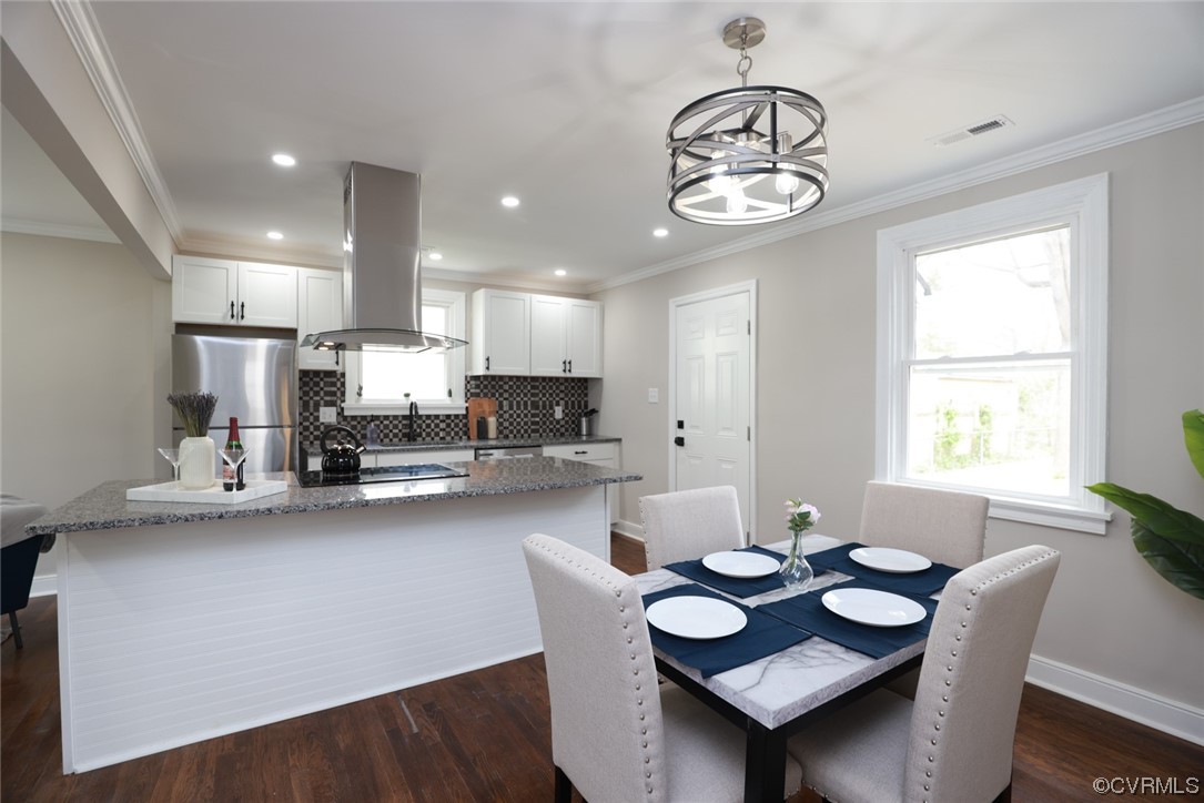 2305 Wright Avenue Richmond, VA 23224 - Photo 14 of 33 a view of a dining room with furniture and a chandelier