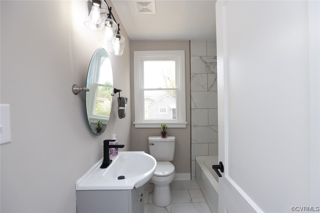 2305 Wright Avenue Richmond, VA 23224 - Photo 15 of 33 a bathroom with a sink a toilet and a mirror