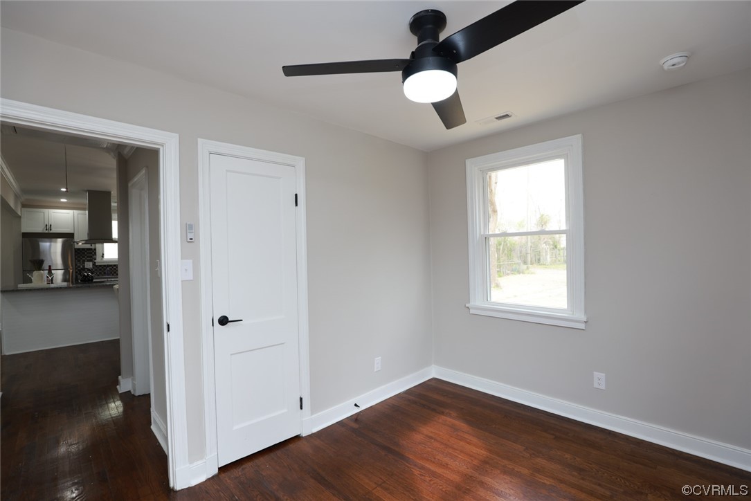 2305 Wright Avenue Richmond, VA 23224 - Photo 17 of 33 an empty room with wooden floor cabinet and windows