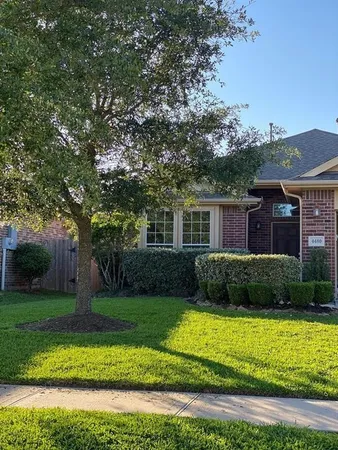 a view of a brick house with a yard