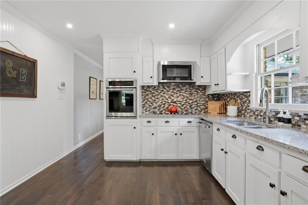 4000 Lower Roswell Road Marietta, GA 30068 - Photo 8 of 25 a kitchen with granite countertop white cabinets and stainless steel appliances