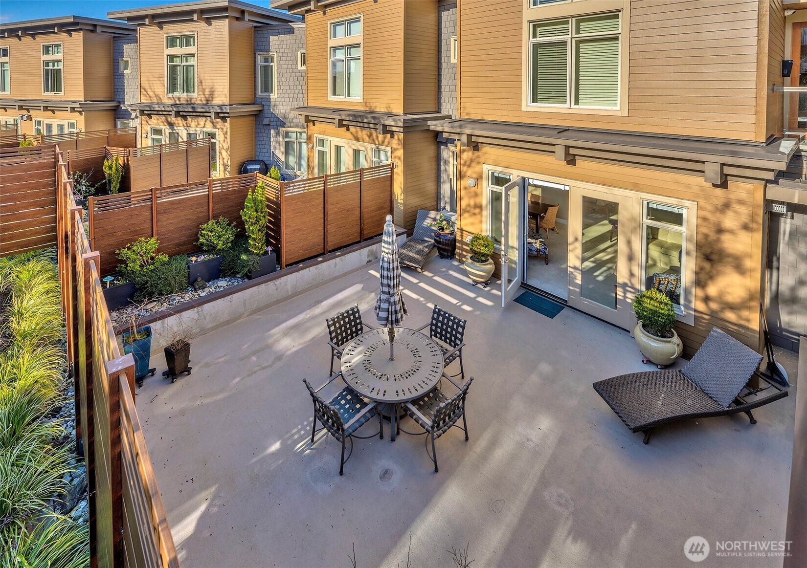 61 Pine Street, Unit 201 Edmonds, WA 98020 - Photo 12 of 34 a view of a patio with couches table and chairs and potted plants