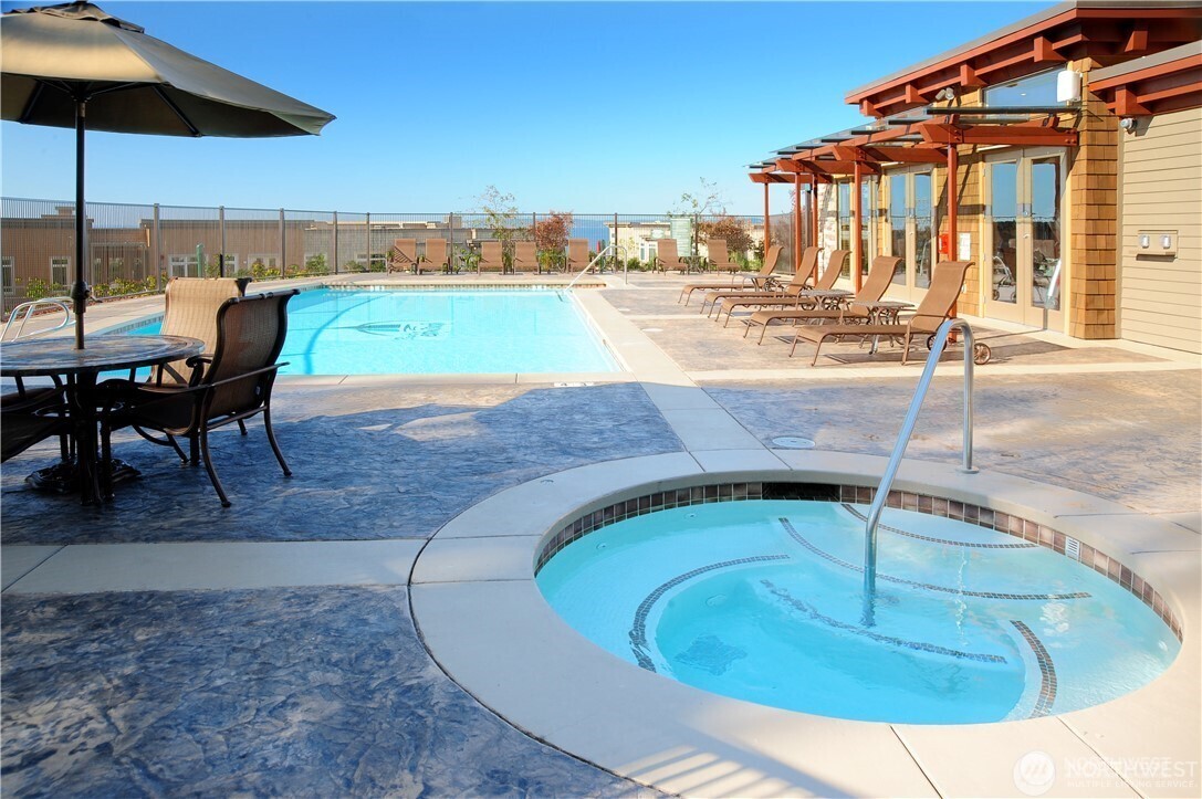 61 Pine Street, Unit 201 Edmonds, WA 98020 - Photo 28 of 34 a view of a swimming pool with a lounge chairs