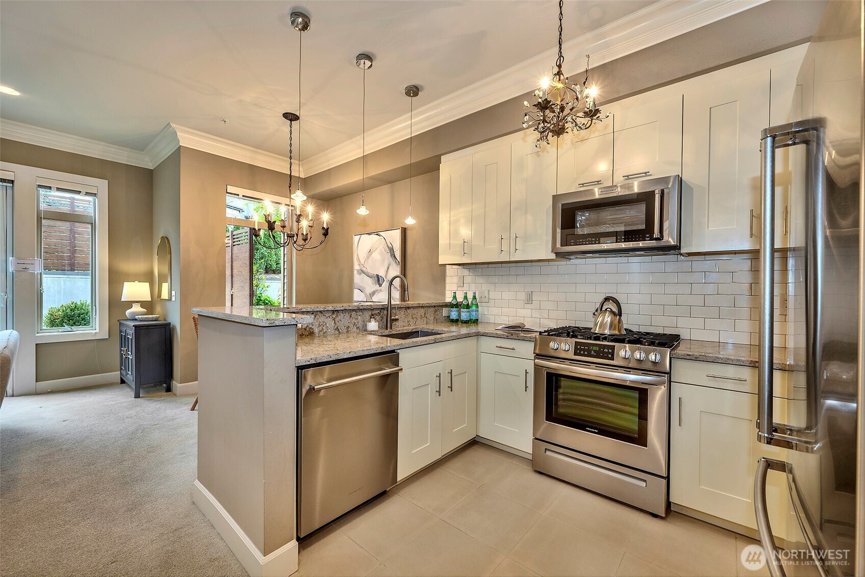 61 Pine Street, Unit 201 Edmonds, WA 98020 - Photo 6 of 34 a kitchen with stainless steel appliances granite countertop a stove a sink and a refrigerator