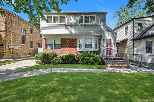 a front view of a house with a garden