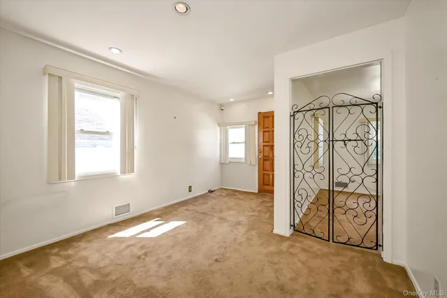 an empty room with windows and closet