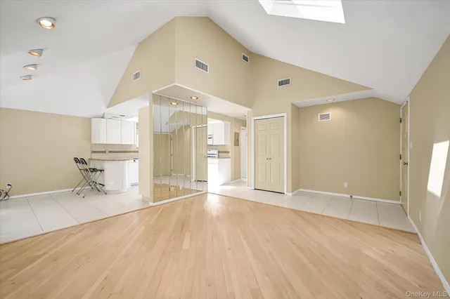 a view of a livingroom with wooden furniture and a ceiling fan