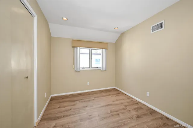 a view of a room with wooden floor and windows