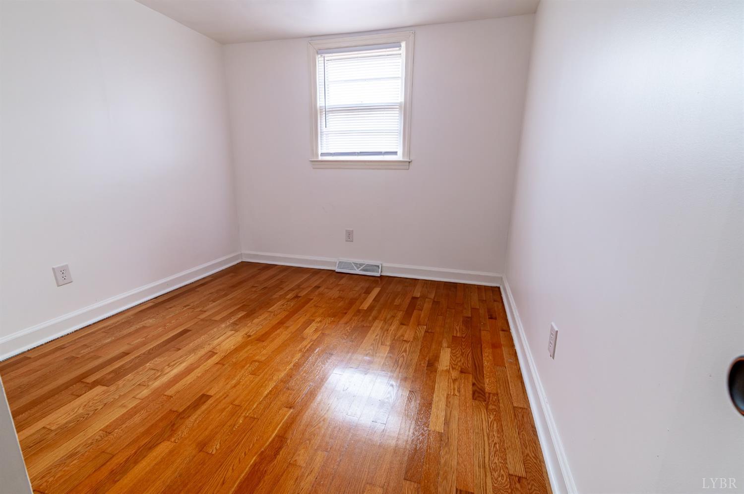 7885 Climax Road Gretna, VA 24557 - Photo 11 of 18 an empty room with wooden floor and windows
