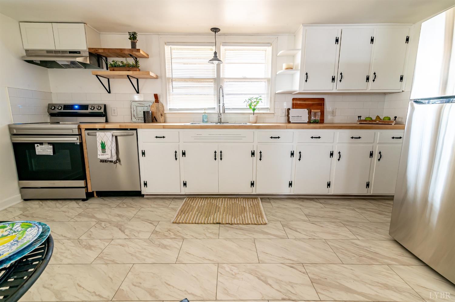 7885 Climax Road Gretna, VA 24557 - Photo 5 of 18 a kitchen with stainless steel appliances a stove a sink and a refrigerator