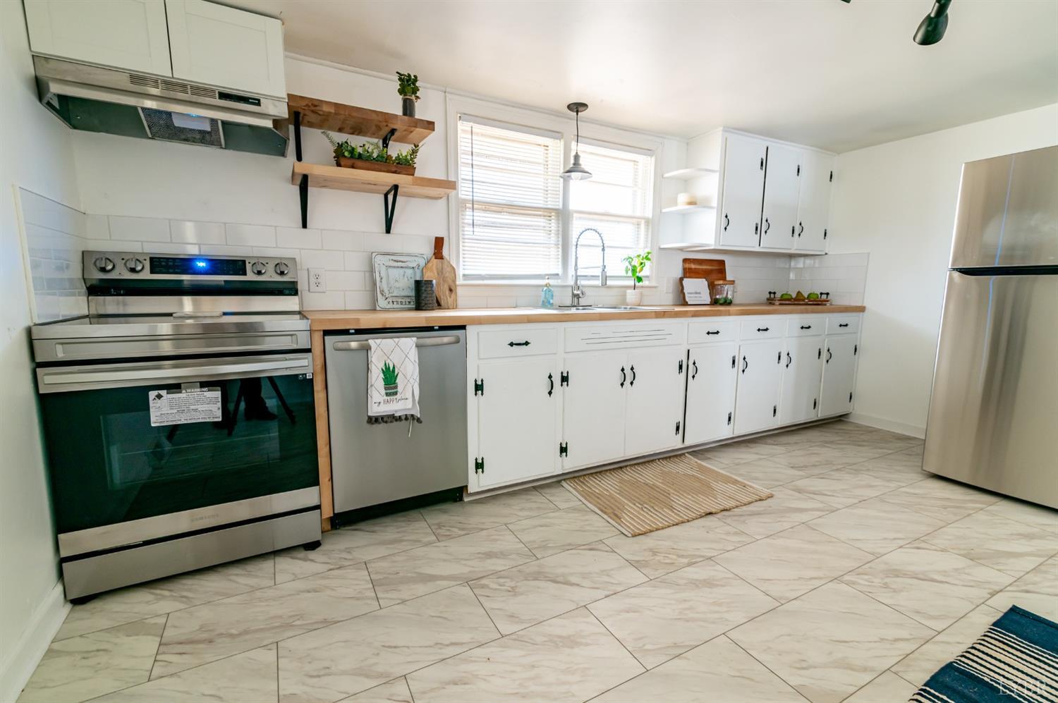 7885 Climax Road Gretna, VA 24557 - Photo 7 of 18 a kitchen with cabinets appliances and a window