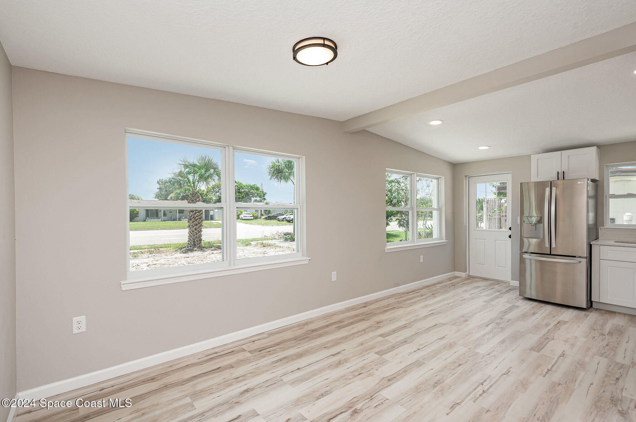 2626 Sarno Road Melbourne, FL 32935 - Photo 11 of 24 a view of empty room with a window and wooden floor