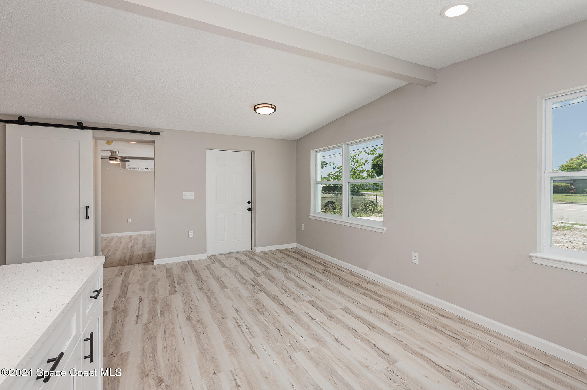 2626 Sarno Road Melbourne, FL 32935 - Photo 14 of 24 a view of a room with a window and wooden floor