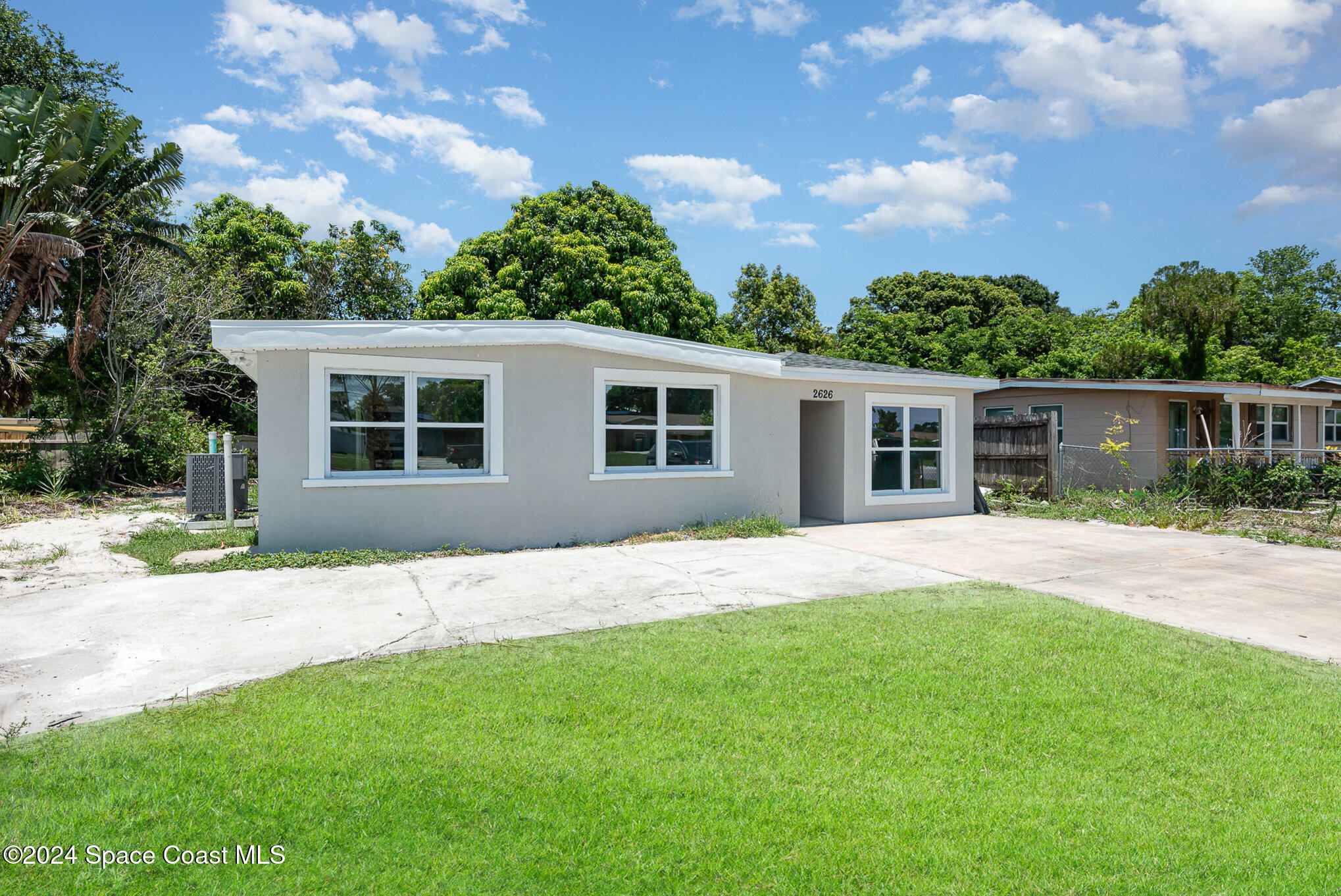 2626 Sarno Road Melbourne, FL 32935 - Photo 17 of 24 front view of a house with a yard