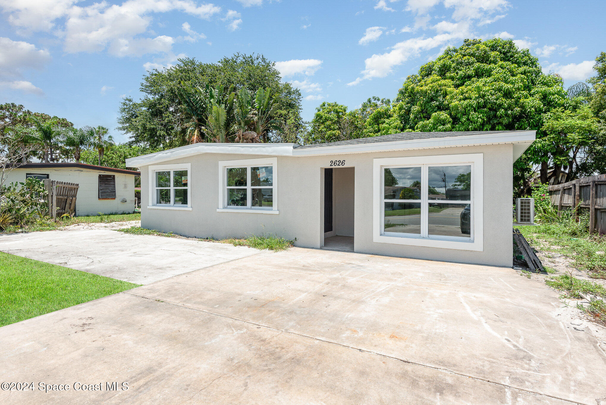 2626 Sarno Road Melbourne, FL 32935 - Photo 20 of 24 front view of a house with a yard