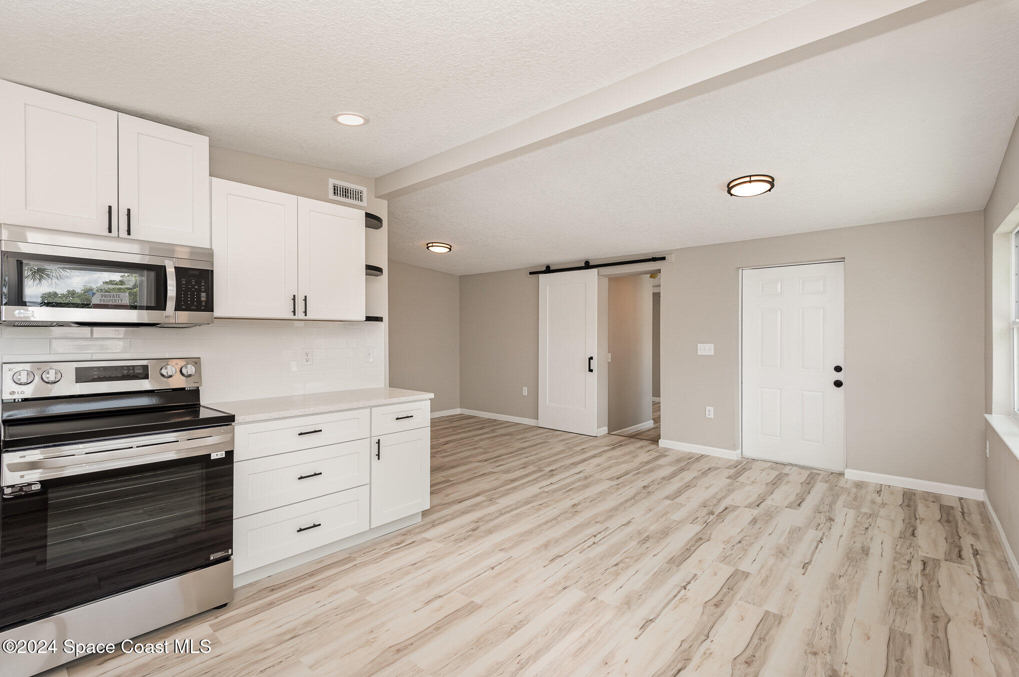 2626 Sarno Road Melbourne, FL 32935 - Photo 2 of 24 a kitchen with stainless steel appliances a stove and a refrigerator