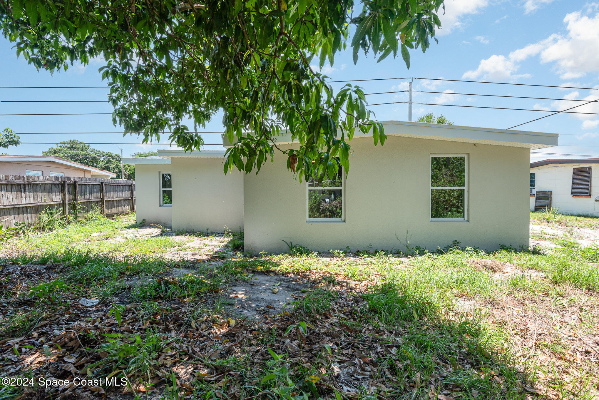 2626 Sarno Road Melbourne, FL 32935 - Photo 23 of 24 a backyard of a house with lots of green space