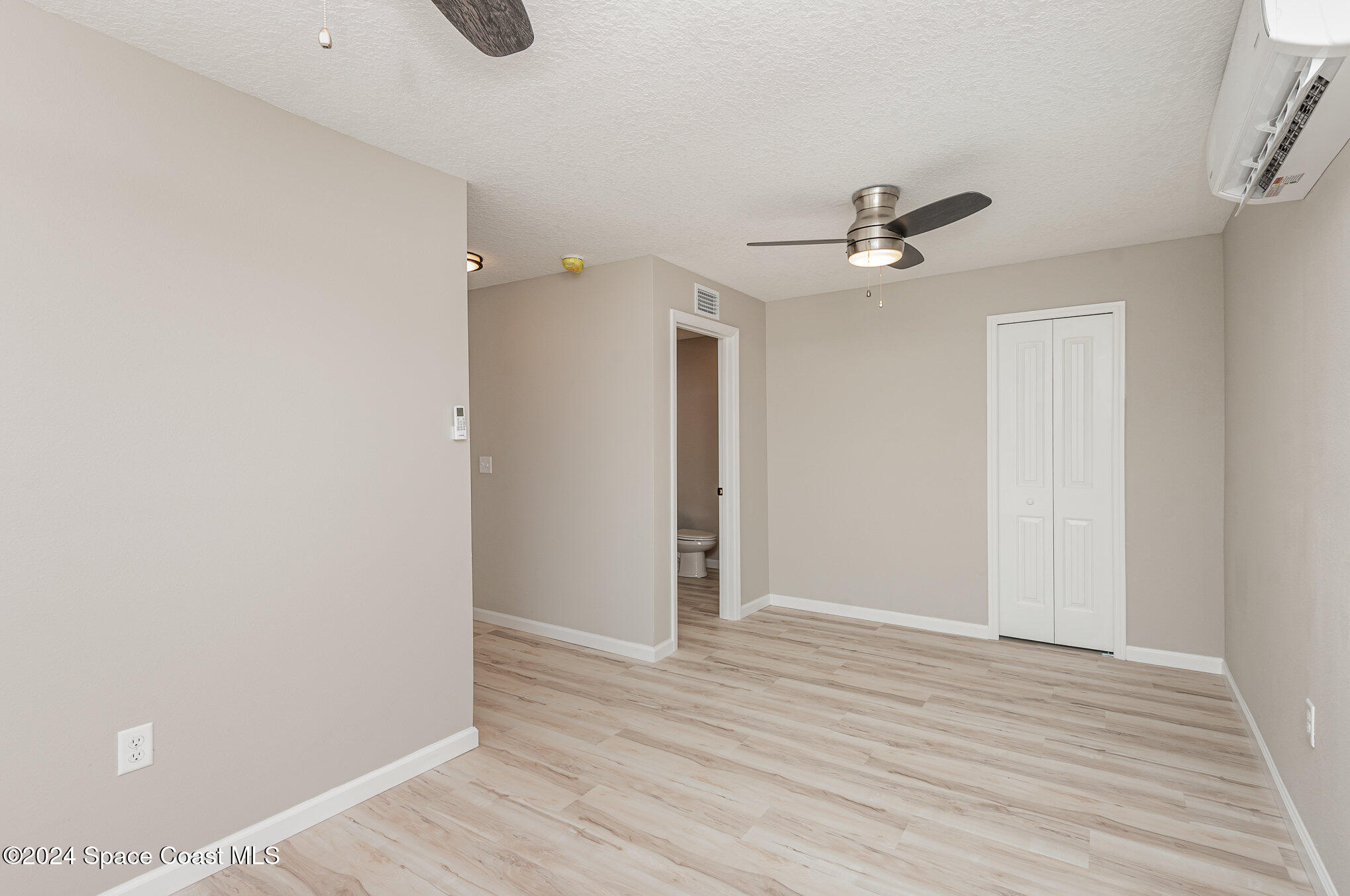 2626 Sarno Road Melbourne, FL 32935 - Photo 7 of 24 a view of an empty room with wooden floor