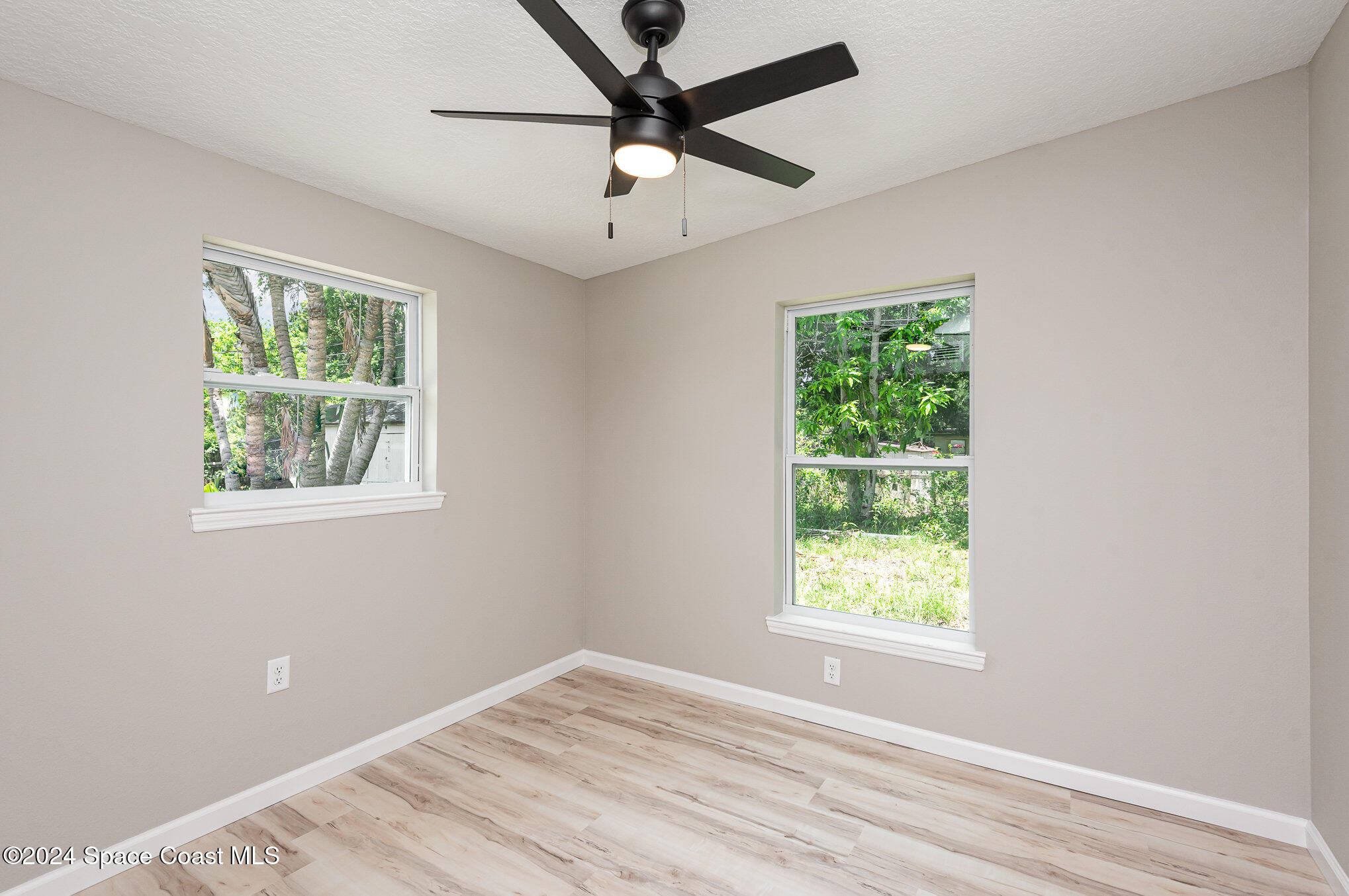2626 Sarno Road Melbourne, FL 32935 - Photo 10 of 24 a view of an empty room with a window