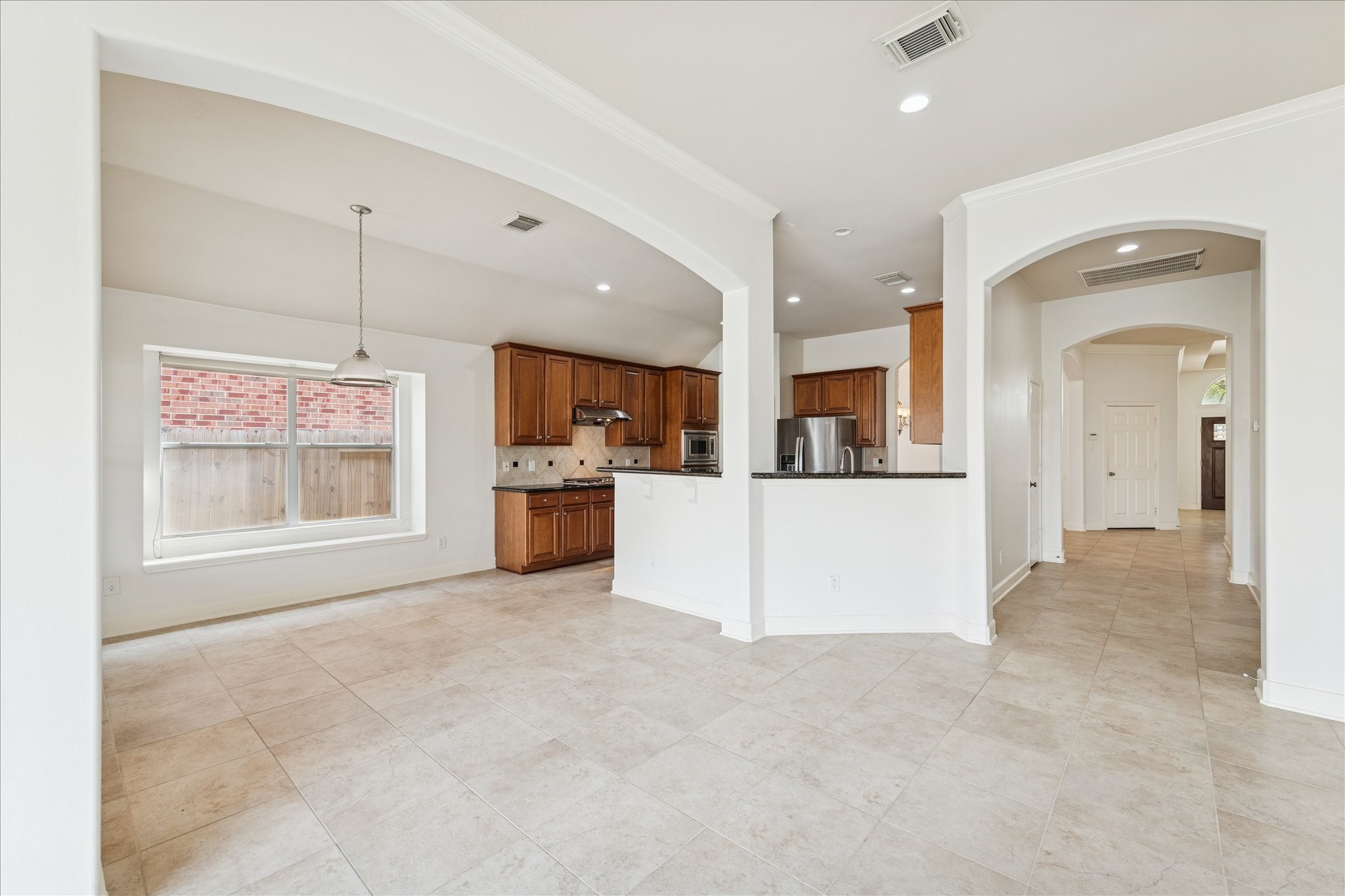 18110 Dunoon Bay Point Court Cypress, TX 77429 - Photo 12 of 27 a view of a kitchen with kitchen island and stainless steel appliances