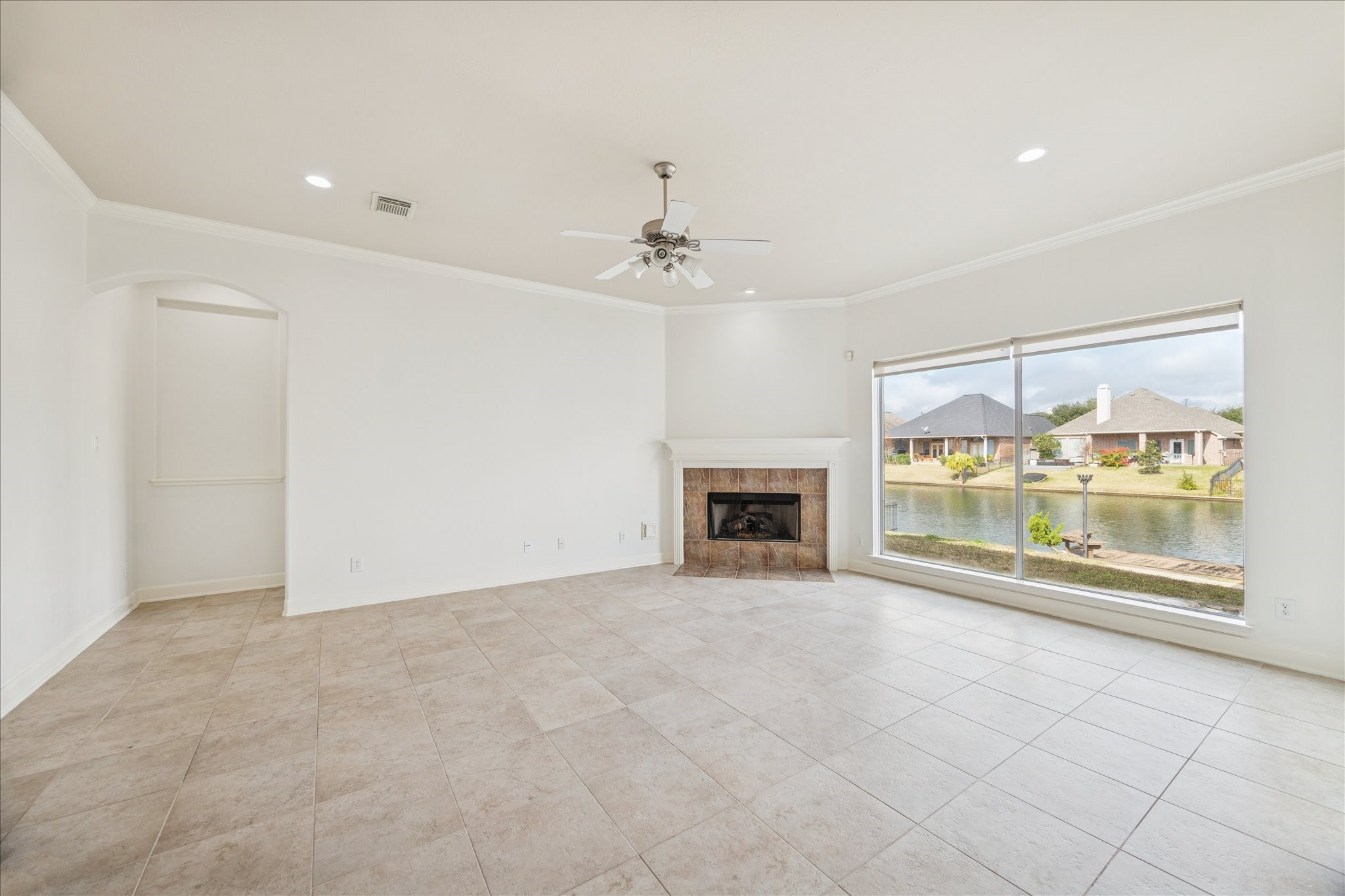 18110 Dunoon Bay Point Court Cypress, TX 77429 - Photo 13 of 27 a view of an empty room with a fireplace and a window