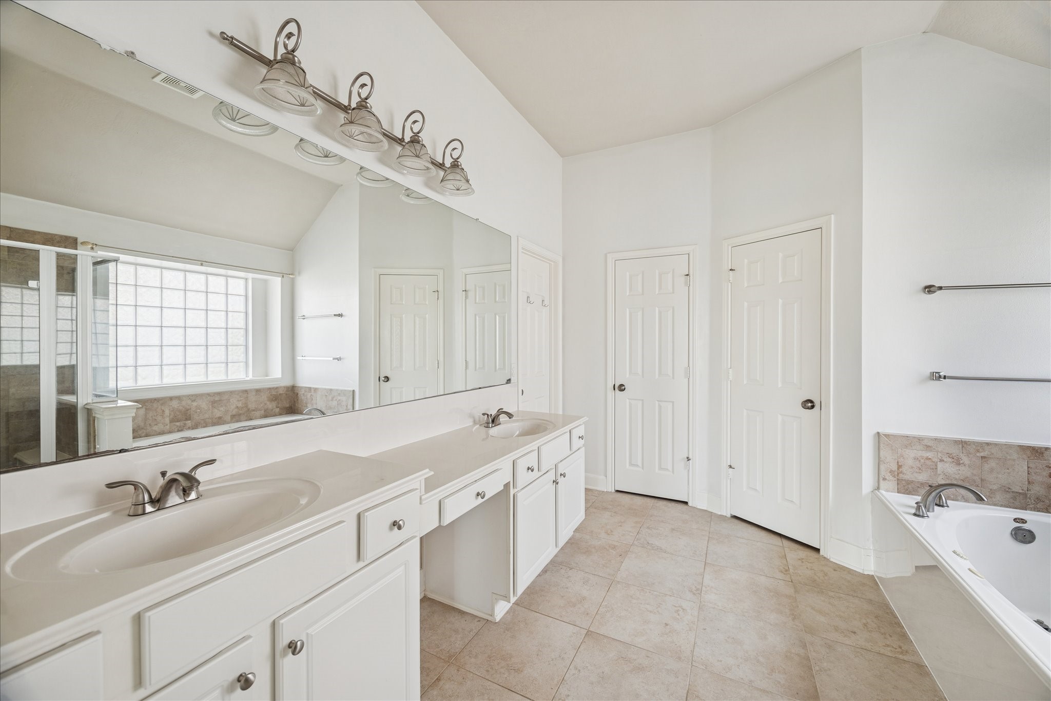 18110 Dunoon Bay Point Court Cypress, TX 77429 - Photo 16 of 27 a spacious bathroom with a tub sink and mirror