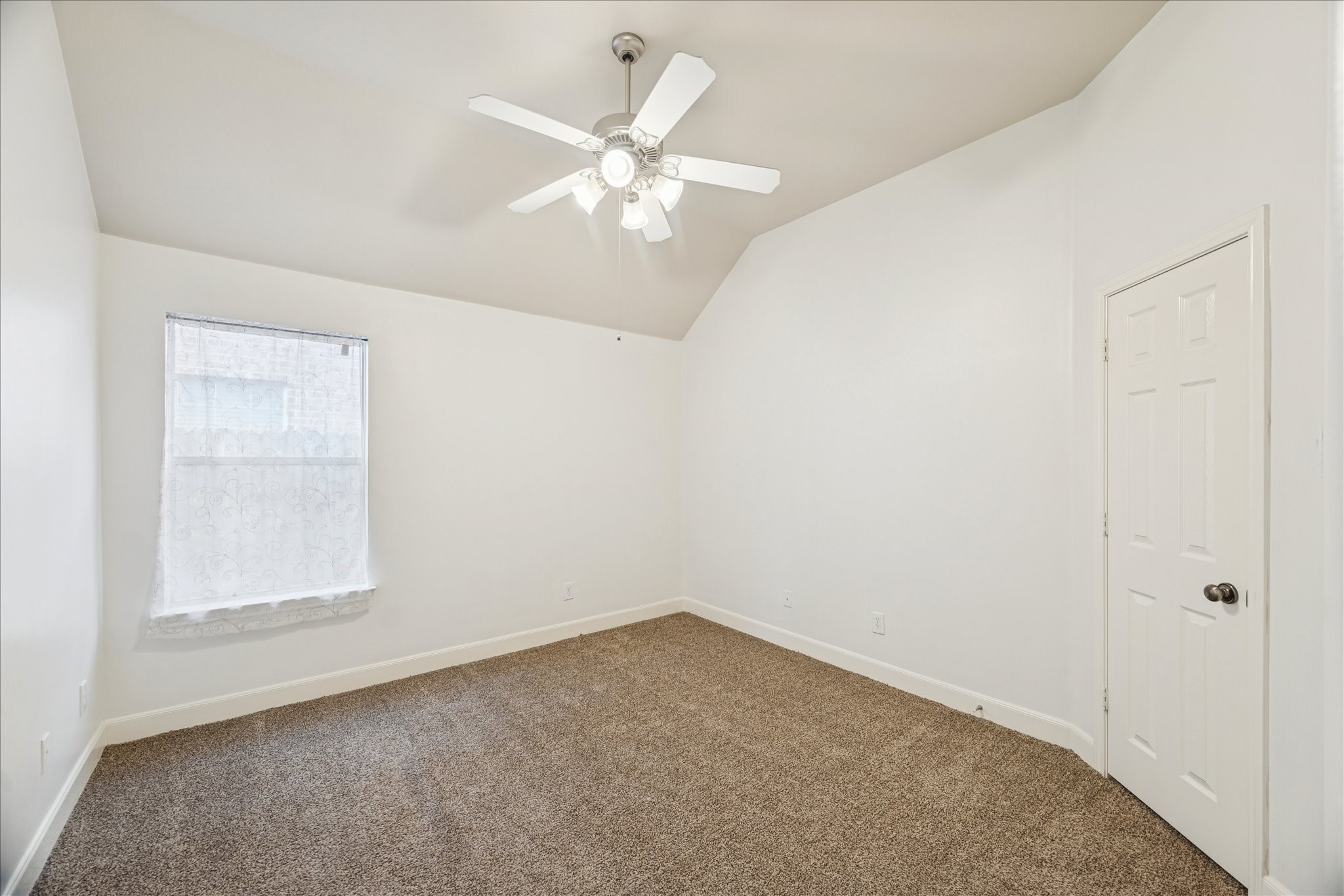 18110 Dunoon Bay Point Court Cypress, TX 77429 - Photo 18 of 27 an empty room with a chandelier fan