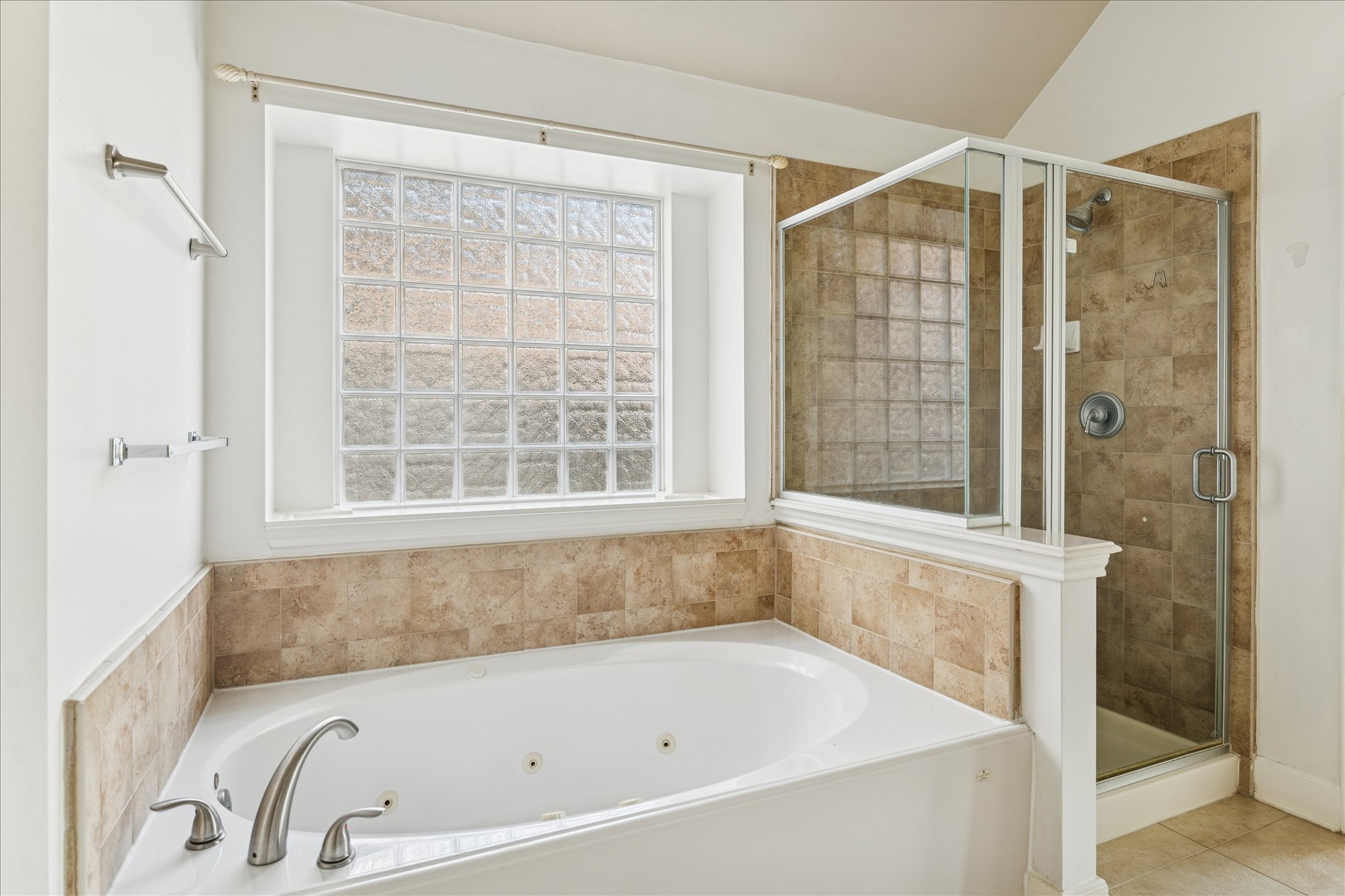 18110 Dunoon Bay Point Court Cypress, TX 77429 - Photo 19 of 27 a bathroom with a bathtub and shower