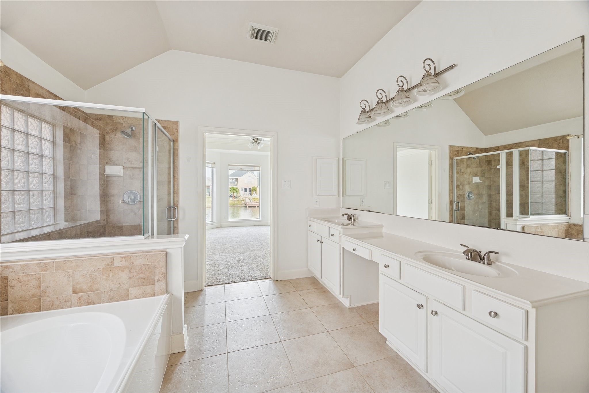 18110 Dunoon Bay Point Court Cypress, TX 77429 - Photo 20 of 27 a spacious bathroom with a tub sink and mirror