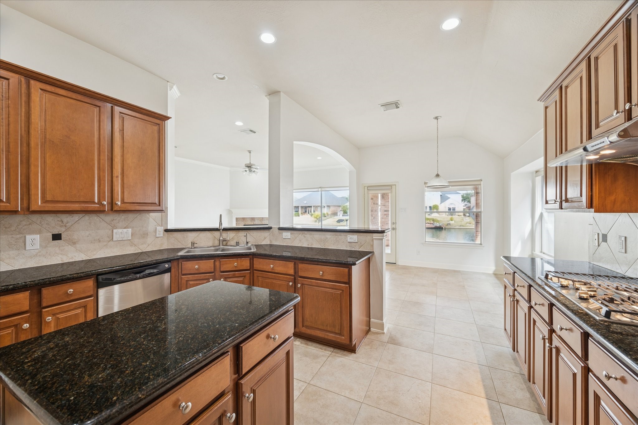 18110 Dunoon Bay Point Court Cypress, TX 77429 - Photo 6 of 27 a kitchen with stainless steel appliances granite countertop a sink stove and cabinets