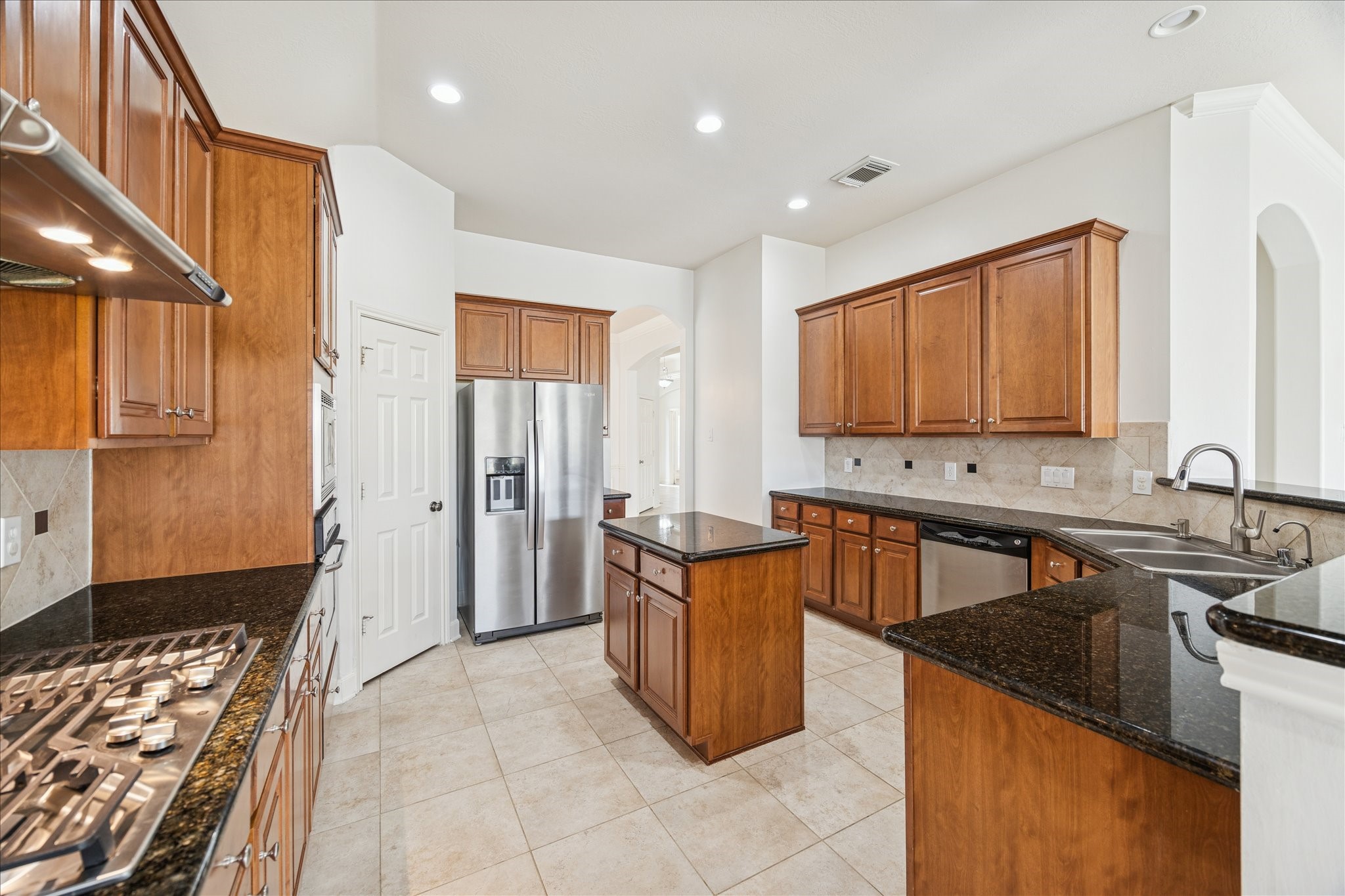 18110 Dunoon Bay Point Court Cypress, TX 77429 - Photo 7 of 27 a kitchen with stainless steel appliances granite countertop a sink stove and refrigerator