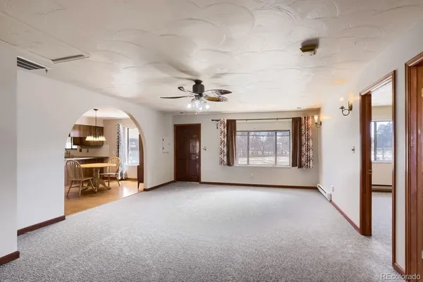 a view of an empty room and a window