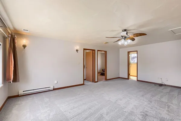 an empty room with windows and closet