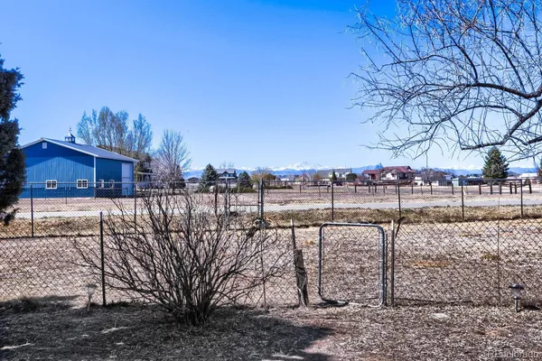a view of a houses with yard and mountain view