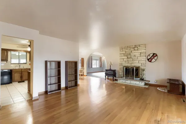a living room with fireplace furniture and a wooden floor