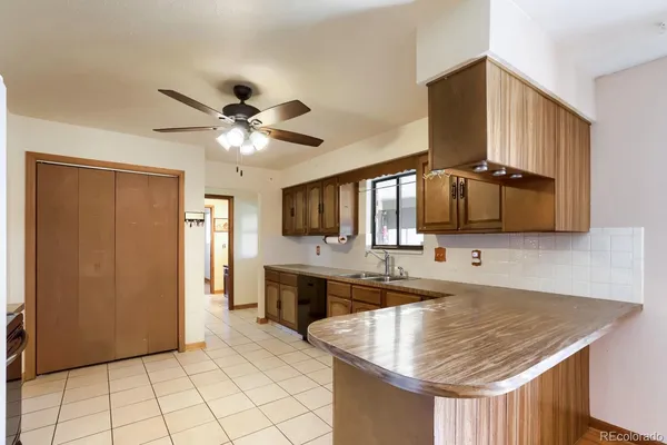 a kitchen with stainless steel appliances granite countertop a sink and a refrigerator
