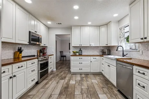 a kitchen with a sink and cabinets