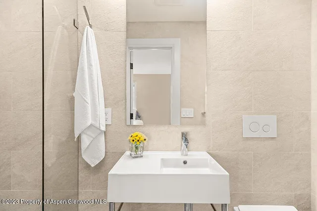 a bathroom with a sink vanity and a mirror