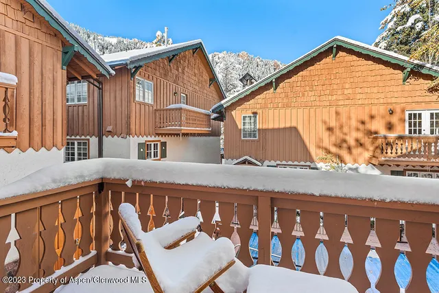 a view of a blue house with a large window