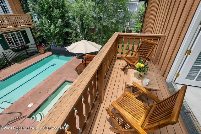 a view of a balcony with wooden floor and outdoor seating