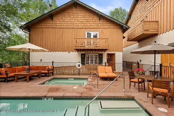 a view of a house with backyard porch and sitting area