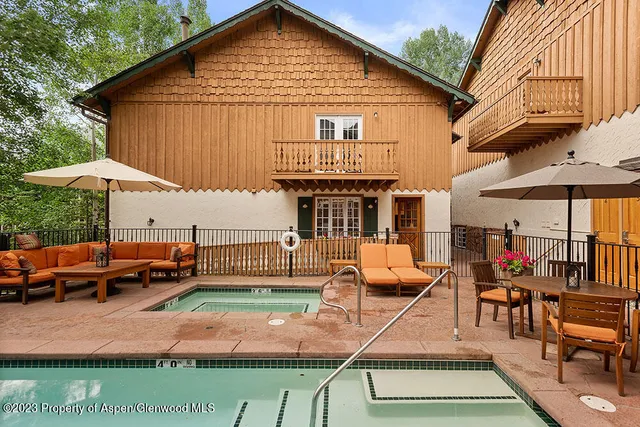 a view of a house with backyard porch and sitting area