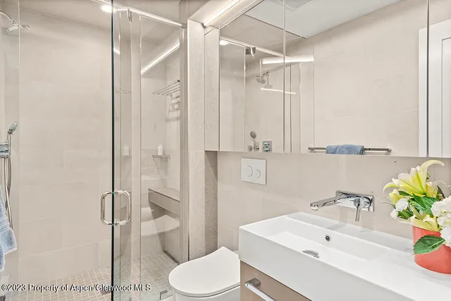 a bathroom with a sink toilet and shower