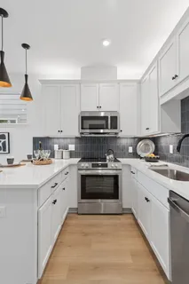 a kitchen with stainless steel appliances granite countertop a sink and cabinets