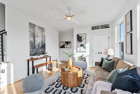 a living room with furniture and a chandelier